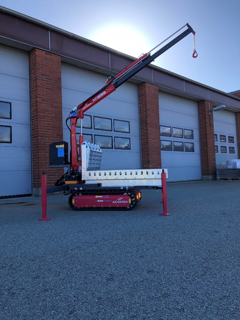 Aconda AC1250 tracked mini-crane with boom raised and outriggers deployed